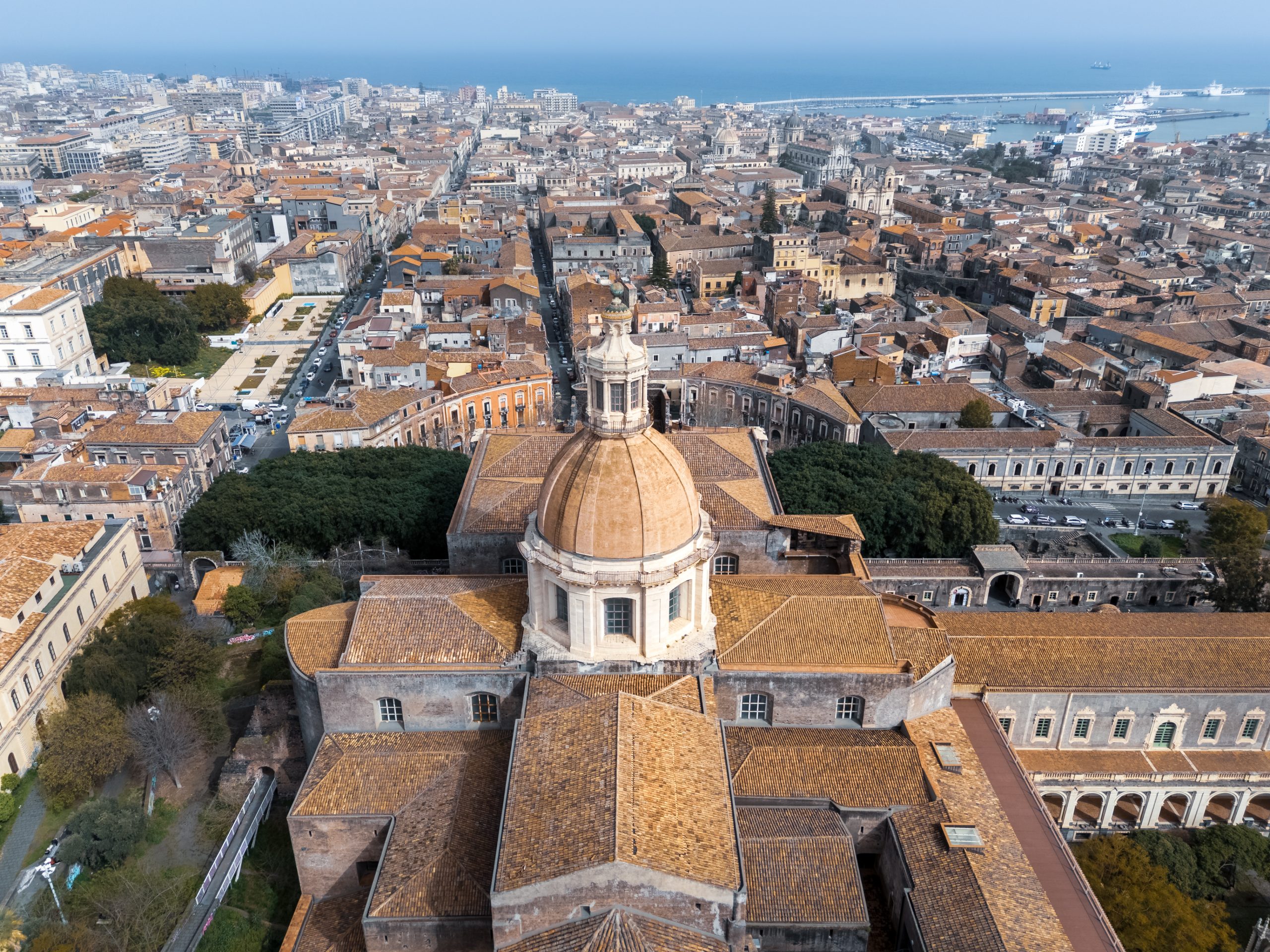 cityscape-with-dome-chiesa-di-san-nicolo-larena-catholic-church-sunny-day-catania-sicily-italy-scaled